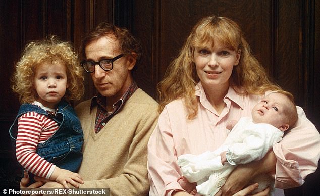 Woody Allen is pictured holding Dylan Farrow, alongside Mia Farrow and their son Ronan