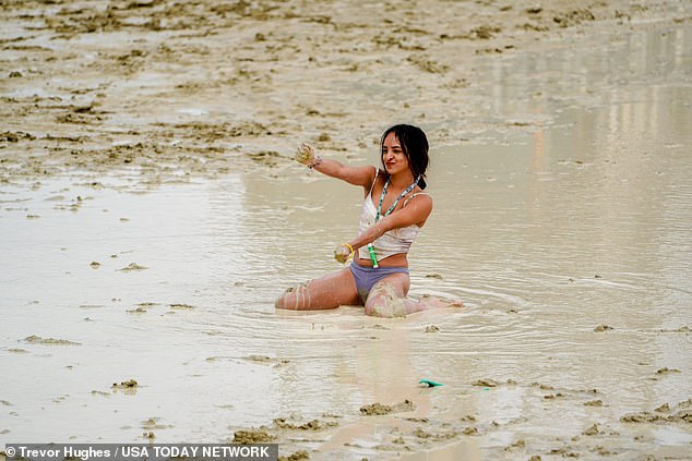 Chicago's Shai Peza dances in the mud after the rain on Saturday