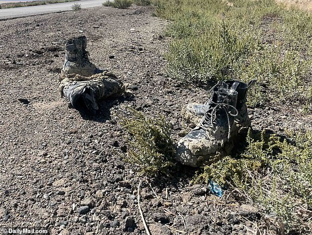 Muddy boots are left on the side of the road on Monday