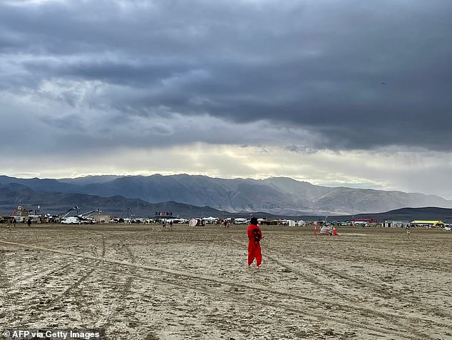 A man examines the muddy scene in Black Rock, Nevada, on Monday