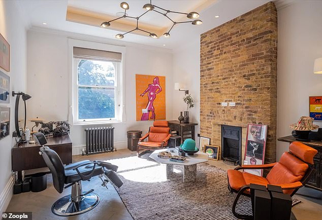 Boy George is known for his sartorial style and several of his hats are on display in this living room along with pictures of iconic singer David Bowie