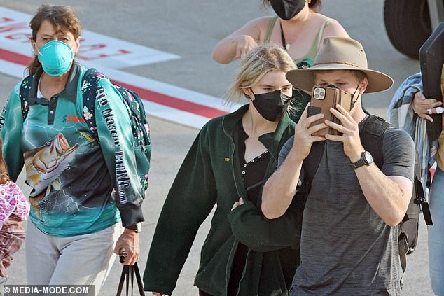 The nature warrior looked relaxed in the aqua and teal sportswear adorned with a barramundi.  Pictured: Robert Irwin (right)