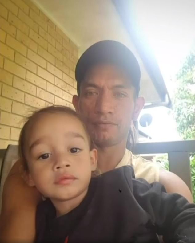 Mr Godinet (pictured with his son) got trapped upstairs with the boys just before the second floor of the house on Russell Island collapsed