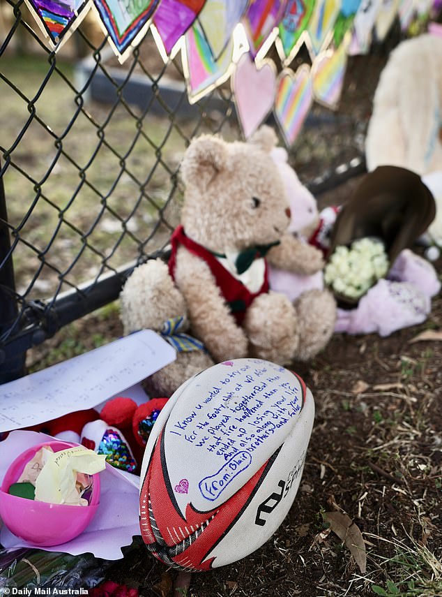 Footballs and teddy bears (pictured) were among the items left behind at the tragic scene