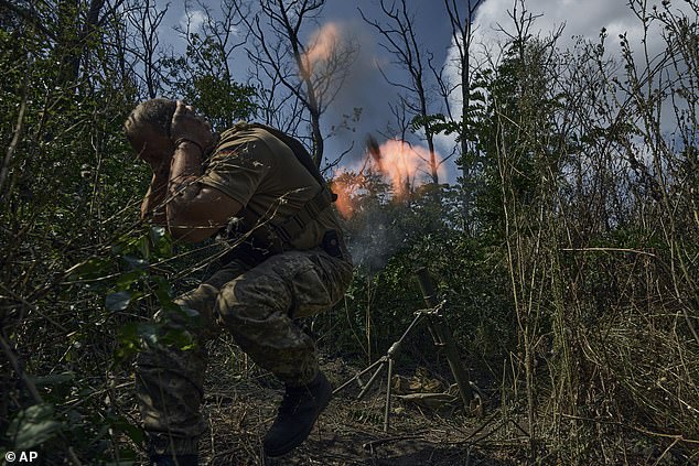 A Ukrainian soldier fires a mortar into Russian positions near Bakhmut, Donetsk region, Ukraine on Saturday