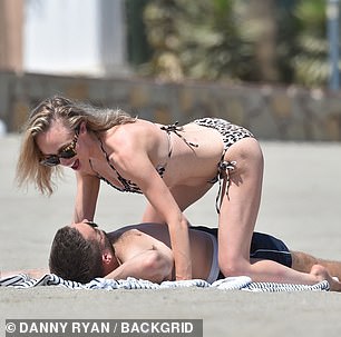 Steamy: Jorgie and Oliver couldn't keep their hands off each other as they rolled in the sand together