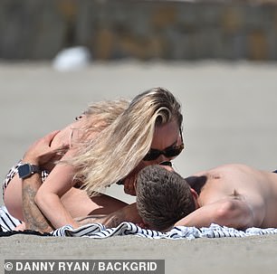 Steamy: Jorgie and Oliver couldn't keep their hands off each other as they rolled in the sand together