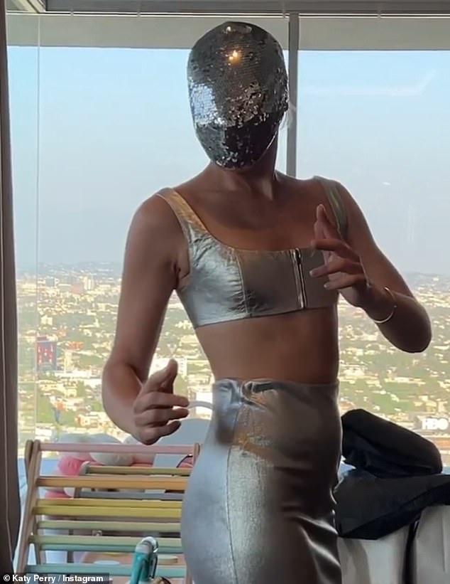 Cheeky in silver: Katy nearly wore a silver face mask on the show as she shared photos of herself getting ready, but later opted out of the dress