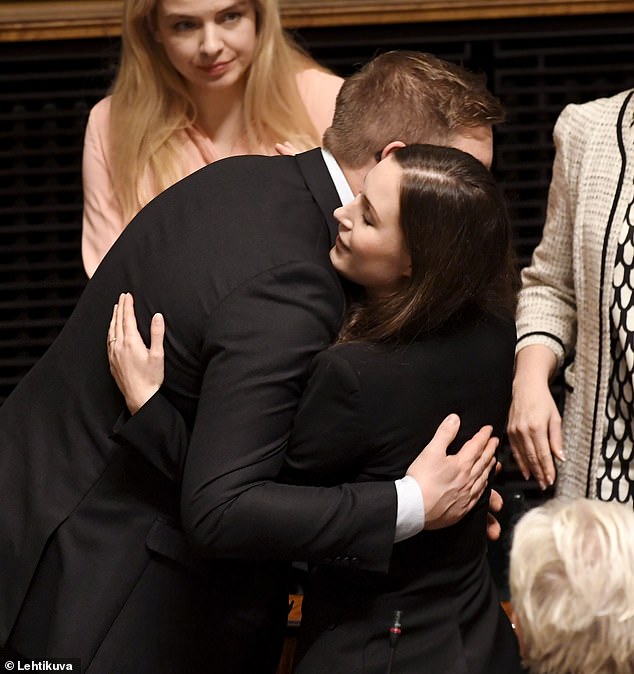 Sanna Marin gets a hug from Social Democrats leader Antti Lindtman, 2019