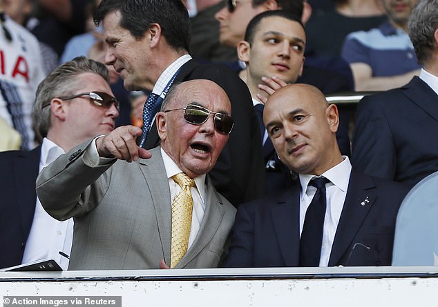 The 86-year-old is pictured next to Spurs chairman Daniel Levy (right) in north London