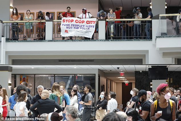 Protesters gather in the atrium of Atlanta City Hall in June to protest the planned police training center