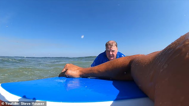 Houser was surfing nearby with his family and filmed himself when he noticed McCabe struggling and rushed over to rescue him