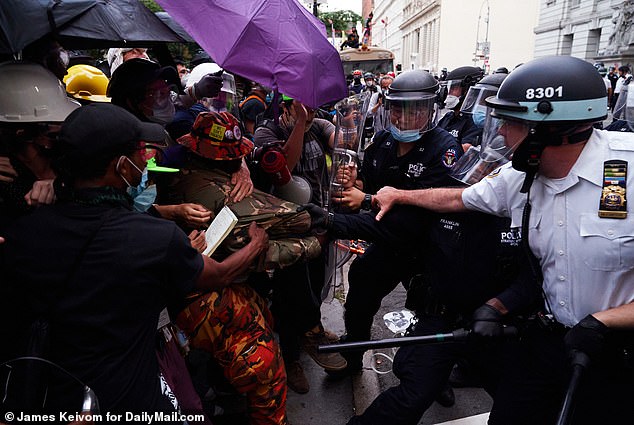 Protesters clash with members of the New York Police Department at City Hall Park on July 1, 2020