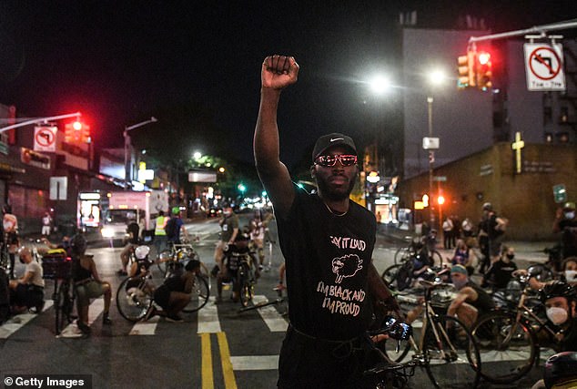 A person raises a fist during a protest on June 6, 2020 in the Flatbush neighborhood of the Brooklyn borough of New York City