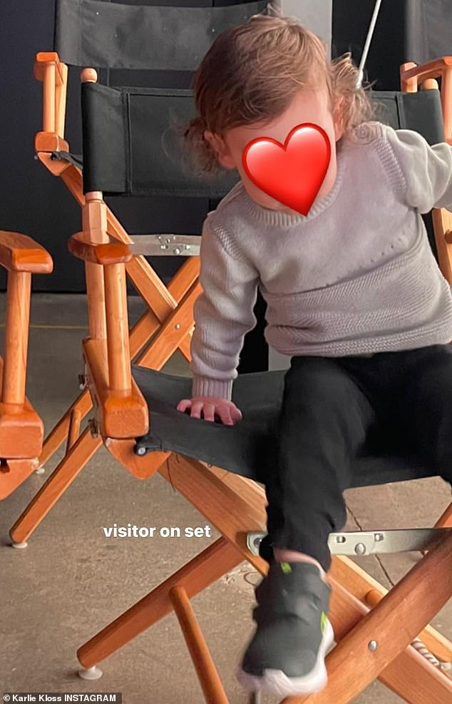 Firstborn: With a heartwarming touch, she also posted a sweet photo of her and Joshua's two-year-old son Levi, sitting in a director's chair, watching his mother at work