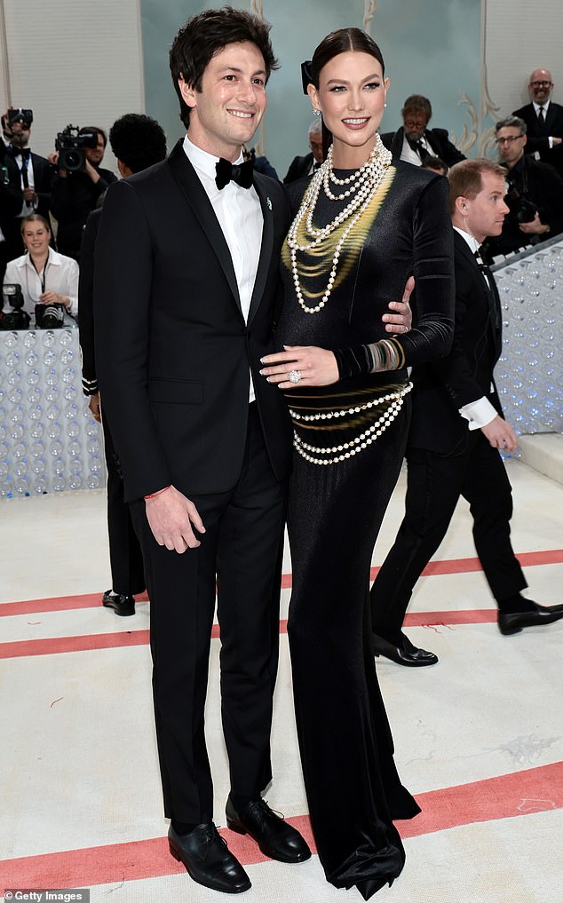 Breaking the news: Karlie gleefully made her current pregnancy public in May at the Met Gala, where she poses alongside her husband