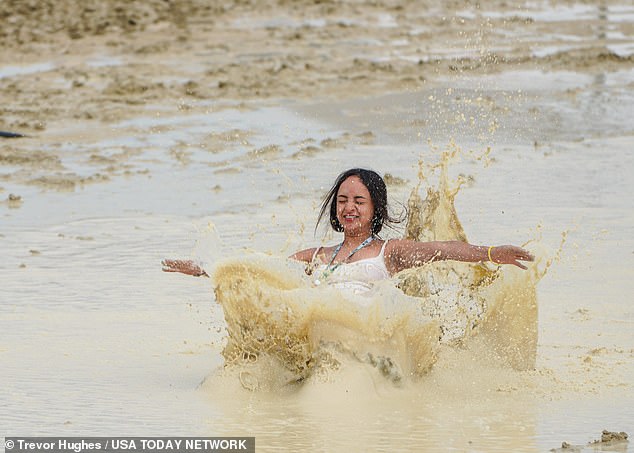 As the freezing storms devastated the festival, some revelers are determined to keep the Burning Man spirit alive.  Pictured: Chicago's Shai Peza frolicking in the mud