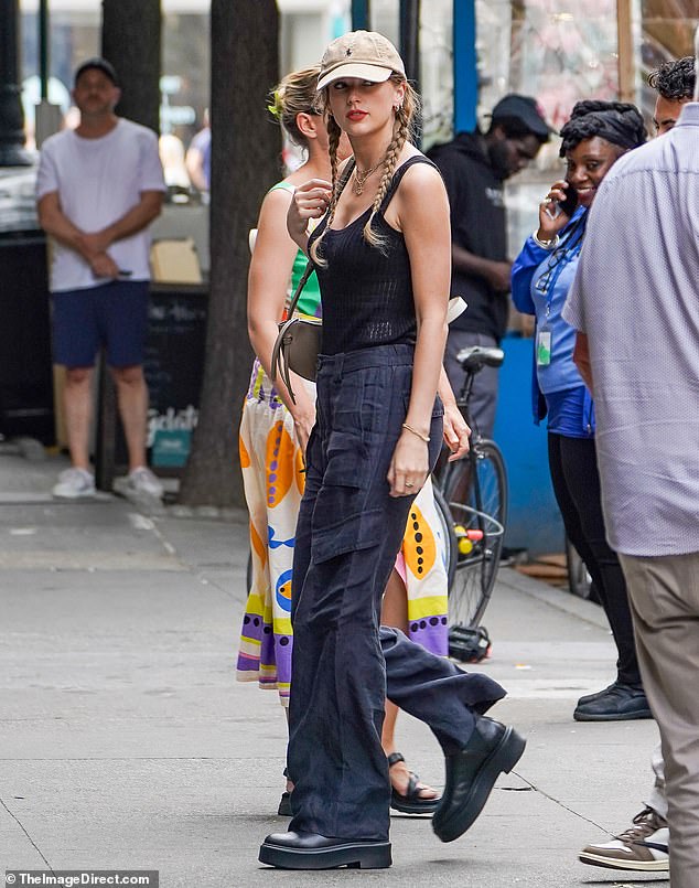 Under the radar: She wore a low-cut black tank top with baggy navy pants and chunky dark boots