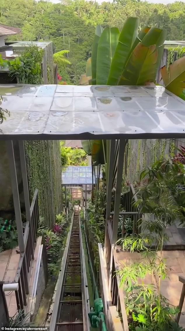 The glass-walled elevator runs along a path along a steep embankment between the resort's ground-floor facilities and the ridge-side accommodation.