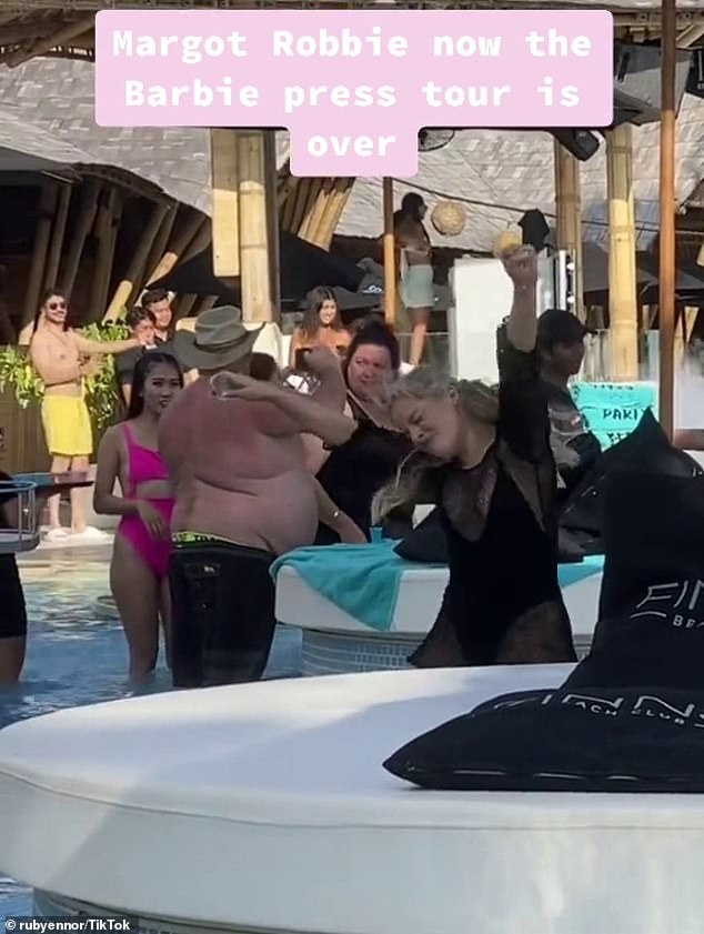 The Margot Robbie lookalike took consecutive shots as she waded through a shallow pool and danced to deafening house music