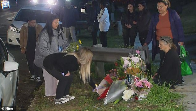 A vigil was held (pictured) for the brother and sister who died in a horror crash when an allegedly stolen Mercedes crashed into their car just yards away from their home in Heckenberg.