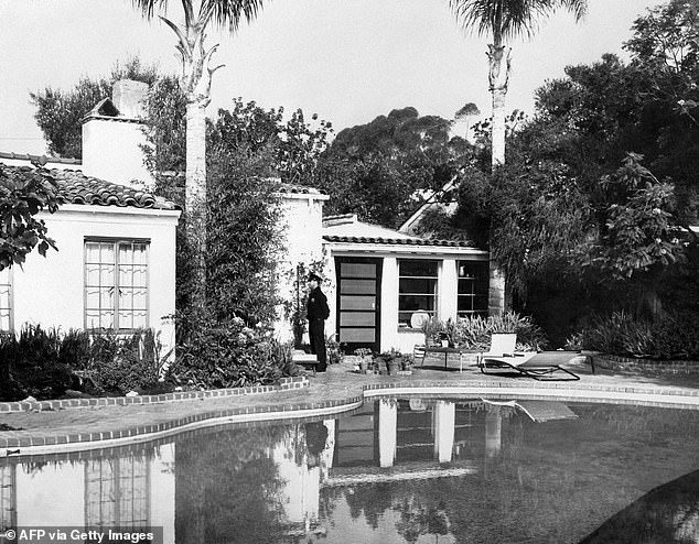 On the day of Monroe's death, a police officer stands in the backyard of the Brentwood home