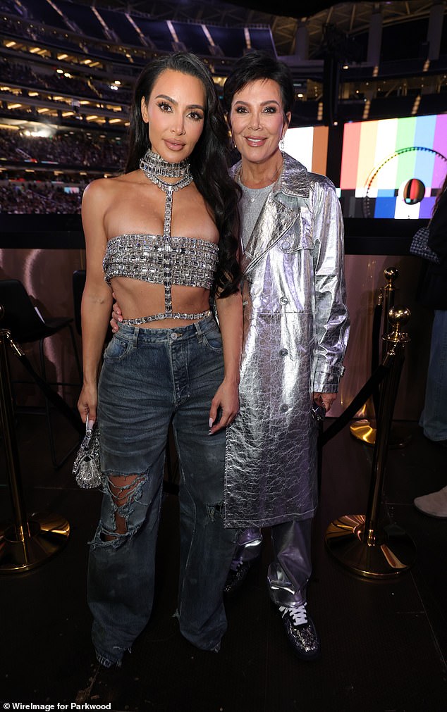 Kim showed off her incredible figure in a bejeweled silver crop top complete with a choker necklace, which she paired with distressed gray jeans