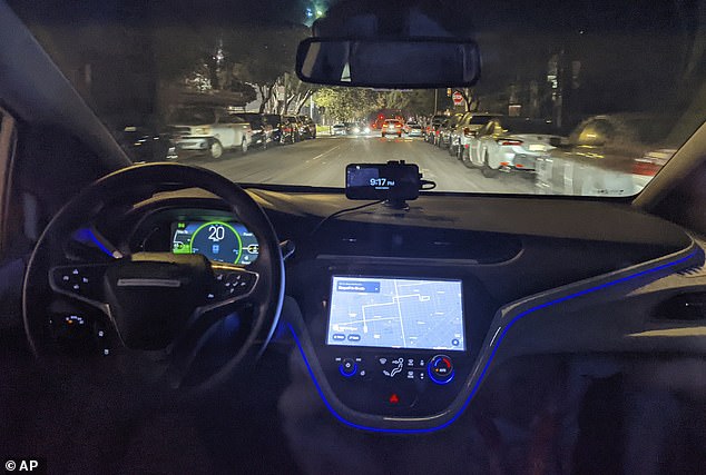 The empty driver's seat is shown in a self-driving Chevy Bolt car named Peaches with Liedtke on board