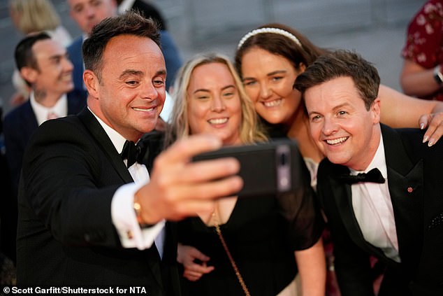 Selfie time: Ant and Dec posed with two fans after arriving for the ceremony