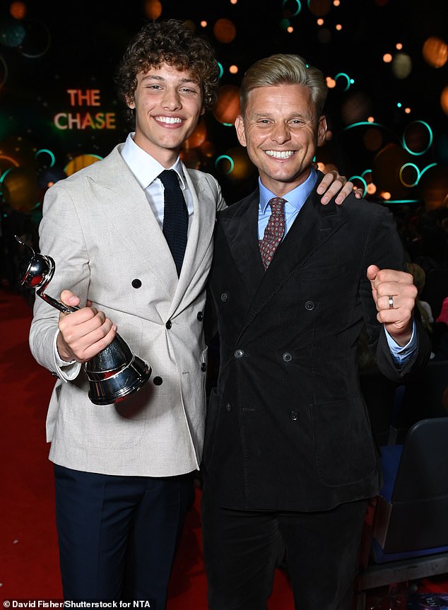 Family: Bobby looked over the moon when he posed next to his dad after winning the award