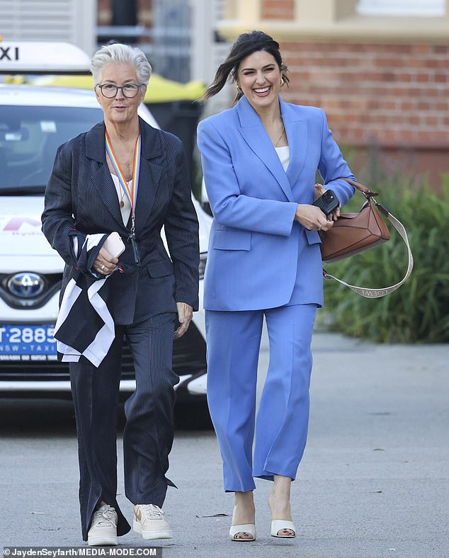 Sarah kept the glamorous slip and wore a white top under the blazer and white heels