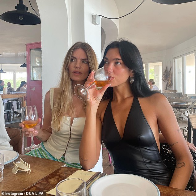 Drink up!  Dua enjoyed a quiet afternoon having drinks with her friend, model Frances Phillips, after flying to Ibiza