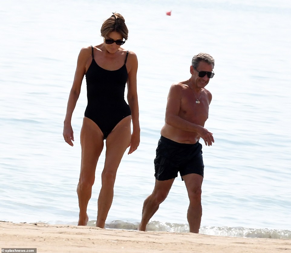 New photos show Sarkozy, 68, in matching black swimming trunks as he laughed with Carla on Monday