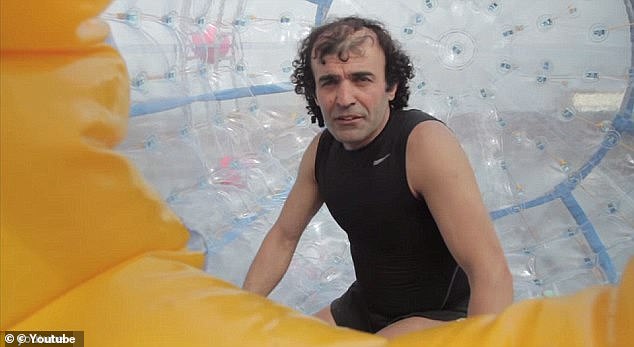 Reza Baluchi (pictured during an earlier attempt) was restrained 70 miles into his journey, which he attempted to cover in a human-powered hamster wheel