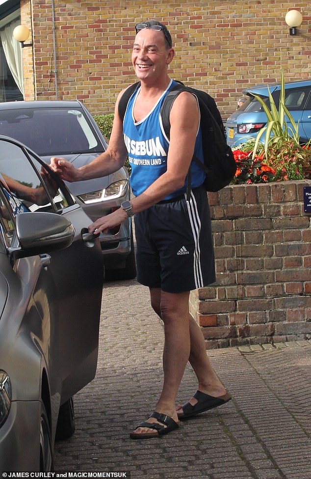 Excited: Judge Craig Revel Horwood, 58, looked as happy as ever as he got in the car and showed off his toned biceps