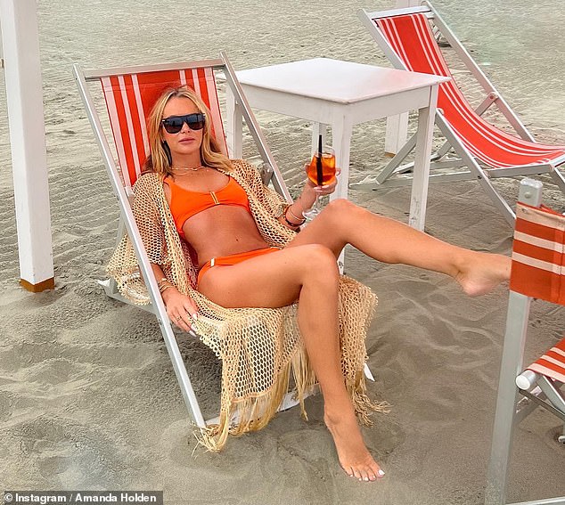 Wow!  Amanda also recently showed off her incredible figure in a skimpy orange bikini while enjoying an Aperol Spritz