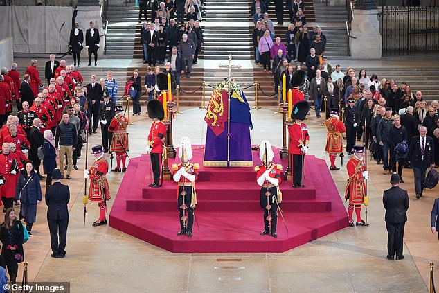 Chelsea pensioners join the crowd as they pay their respects to Her Majesty's coffin in her adjournment at Westminster Hall