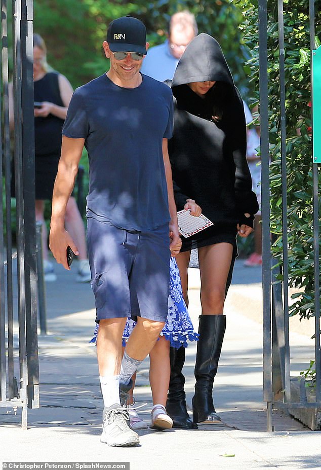 Cool and casual: The leading man stood in front of the two ladies in his life as he rocked a pair of tie-dyed blue socks and gray tennis shoes