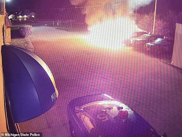 Surveillance footage captured the moment when one of the police cars caught fire and crashed into a wall of flame that engulfed the neighboring vehicle