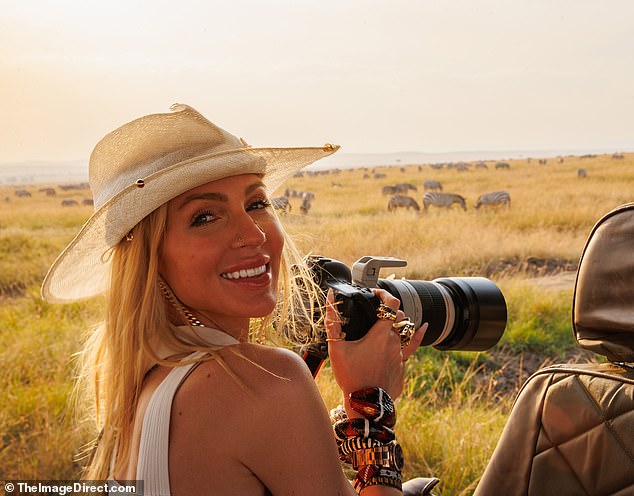 Wildlife photographer: The former Selling Sunset star, 34, looked like she was recreating scenes from the iconic 1985 movie Out of Africa as she wielded a professional-looking camera with a giant zoom