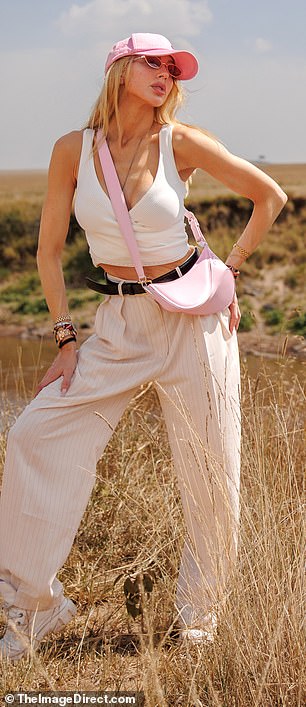 Hat trick: she swapped her hats several times, alternating between a straw cowboy hat, a classic fedora, a pink ball cap, and a black ball cap