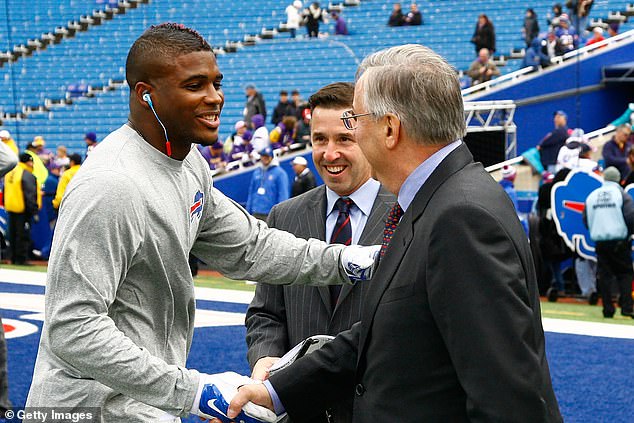 Williams shakes hands with Bills owner Terry Pegula (right) before a game against the Vikings