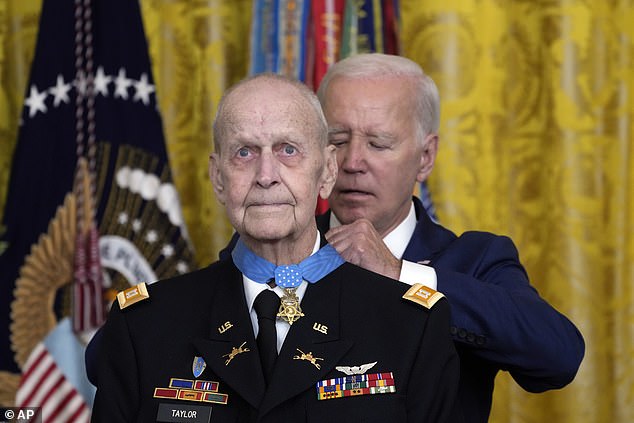 President Joe Biden (right), whose wife tested positive for COVID-19 on Monday, places the Medal of Honor around the neck of 81-year-old retired Army Captain Larry Taylor, who saved four men during the Vietnam War thanks to his helicopter piloting heroics