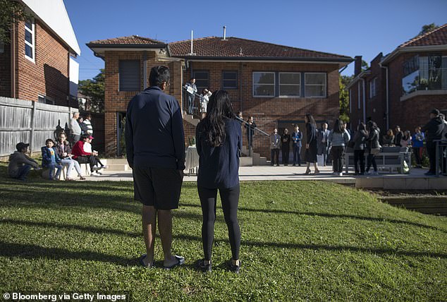 Underquoting, which is illegal, is seen as a major problem for buyers in the housing market.  Pictured: People at an auction in Sydney in May 2023