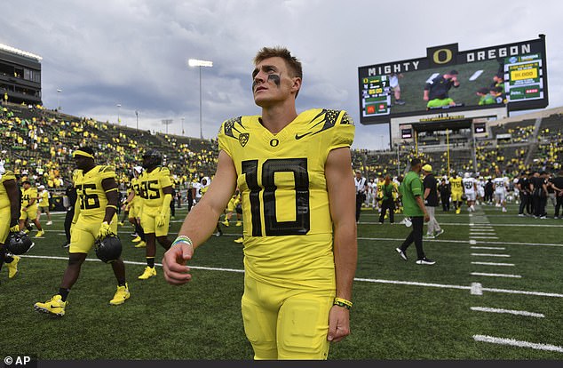 Oregon quarterback Bo Nix threw for 287 yards and three touchdowns before sitting out early