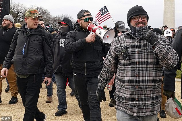 Proud Boys members, including Zachary Rehl, left, Ethan Nordean, center, and Joseph Biggs, walk toward the U.S. Capitol in Washington, in support of President Donald Trump