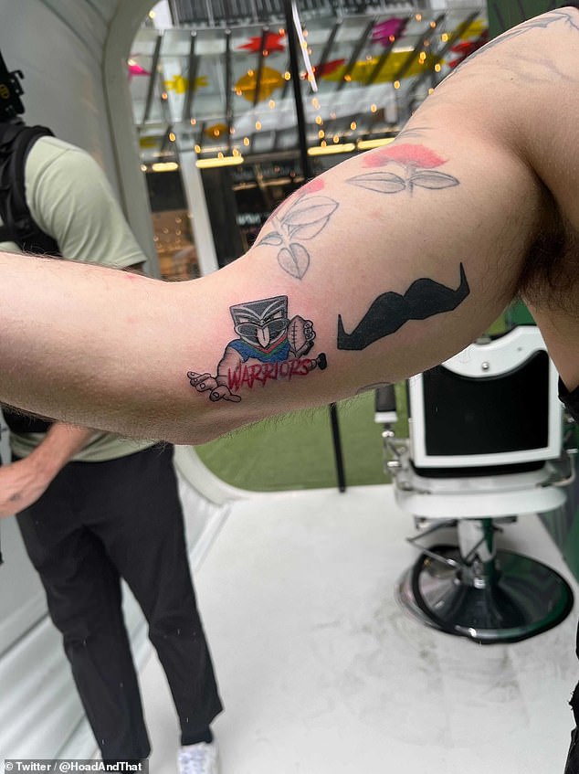 Those brave enough were not given a say in the choice of ink - they simply stuck their arm through the hole and let the artist get to work (photo, one of the finished designs)