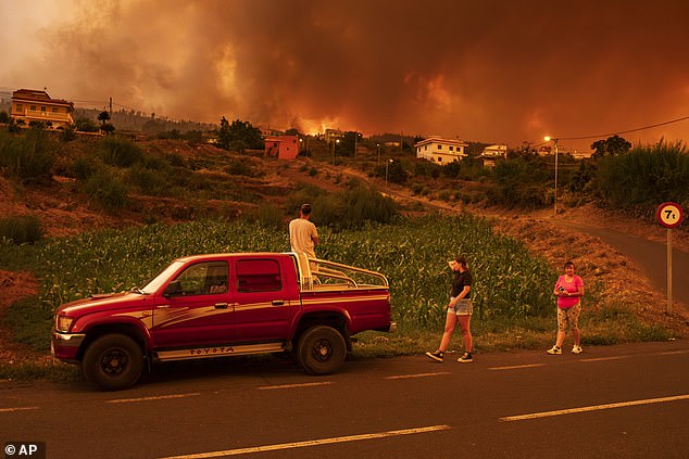 Local residents try to reach their homes in the village of Benijos as the fire spreads in La Orotava in Tenerife, Canary Islands, Spain on Saturday, August 19, 2023