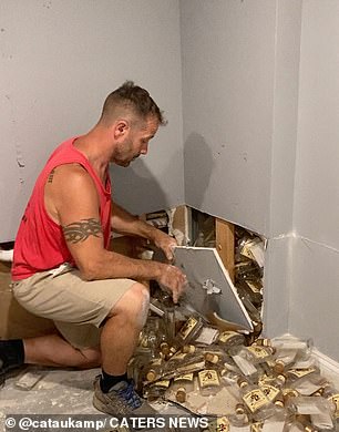 After removing part of the dry wall, Roy looks at the camera as he moves the bottles around the room, before shaking his head