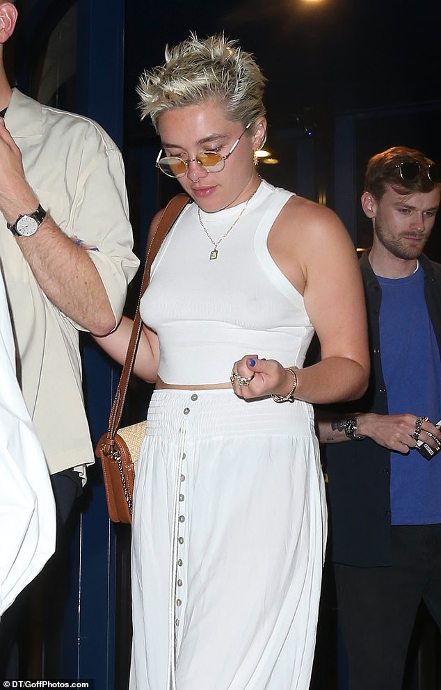 Stylish: The actress, 27, went braless in a white crop top and floaty white skirt, which she styled with a pair of quirky embroidered platform mules